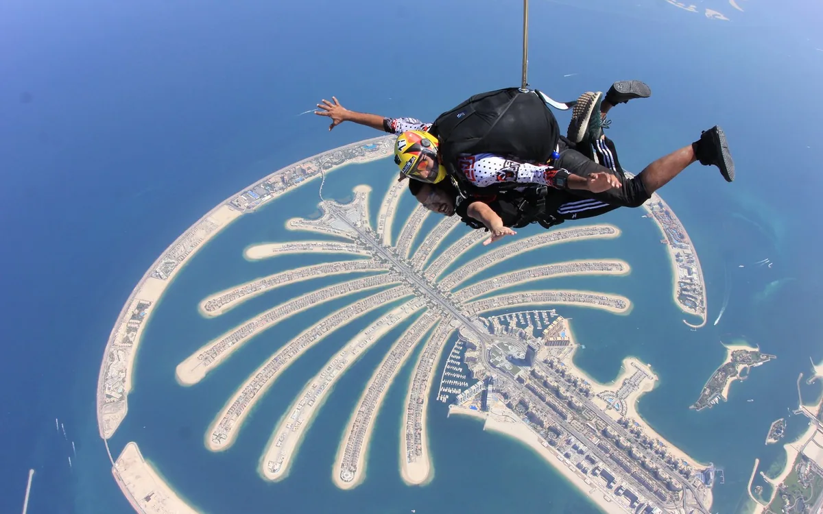 A tandem skydiver in freefall above Palm Jumeirah